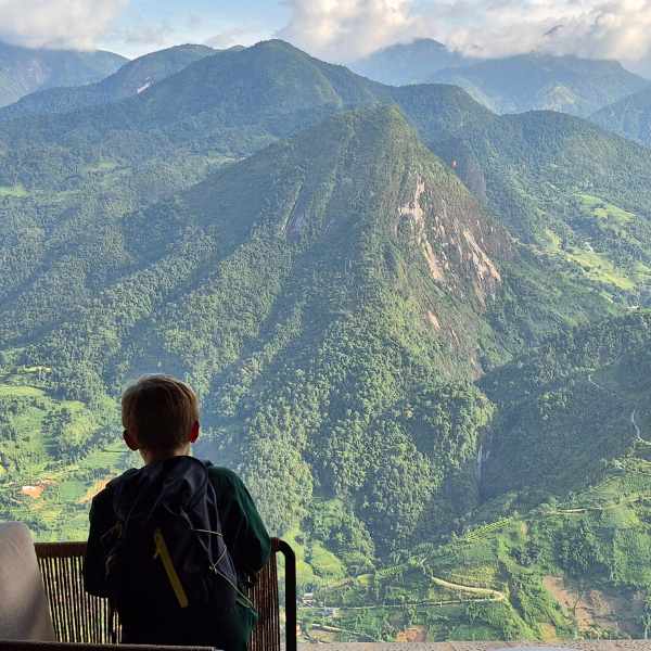 North Vietnam - boy looking over mountain view - LiNGER Travel